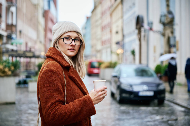 Woman at city street with coffee cup - Photo, Image