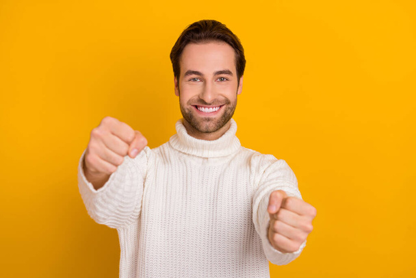 Photo of pretty charming guy dressed white sweater driving automobile isolated yellow color background - Photo, Image