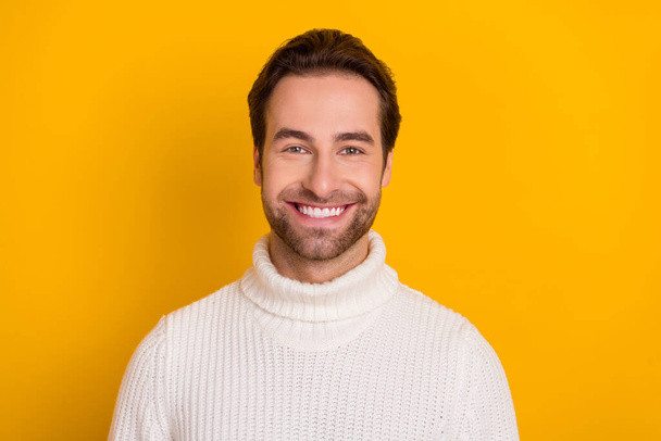 Photo of cheerful bearded guy shiny beaming smile wear white pullover isolated yellow color background - Valokuva, kuva