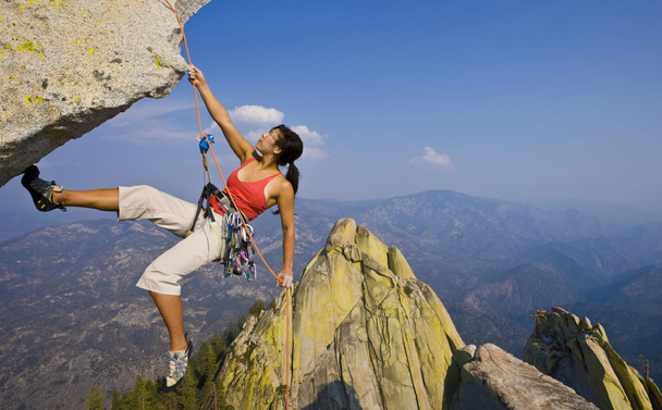 Female rock climber rappelling. - Photo, Image