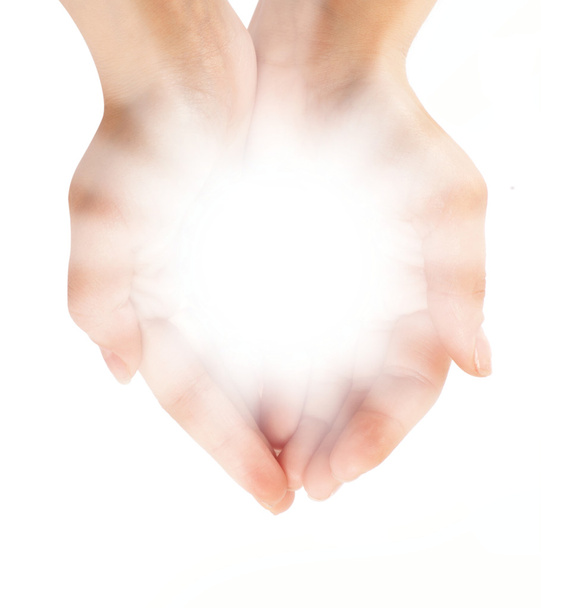 Female hands holding a brilliant shine in the dark - Foto, Bild