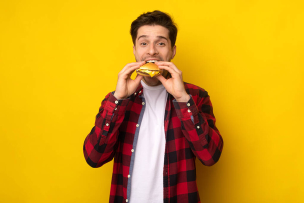 Hauska nälkäinen kaveri tilalla hampurilainen puree voileipä Studio - Valokuva, kuva
