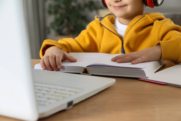 Cute little boy with modern laptop studying online at home, closeup. E-learning - Φωτογραφία, εικόνα