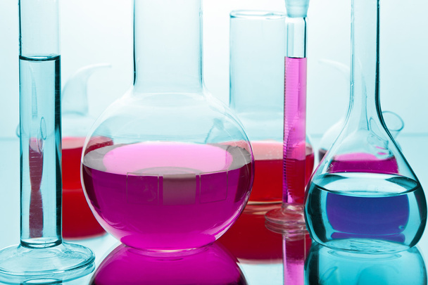 Laboratory glassware with colorful chemicals - Photo, Image