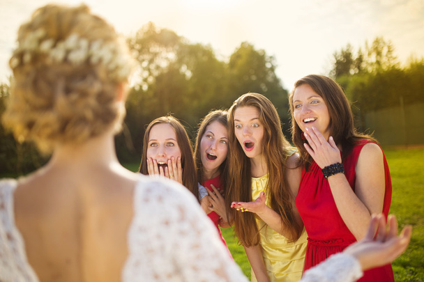 Surprised bridesmaids looking at bride - Foto, afbeelding