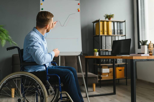 Man in wheelchair at home or in office. - Valokuva, kuva