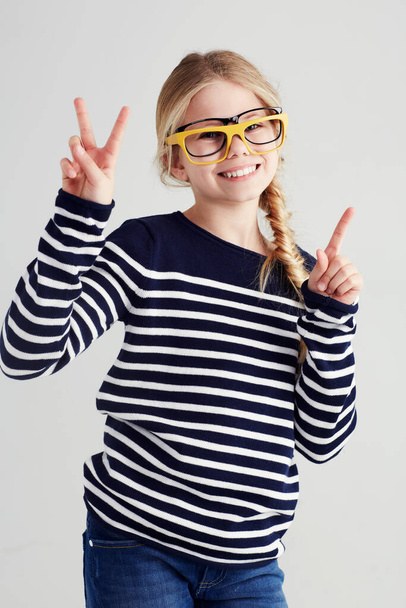 Shes a playful hipster in the making. Portrait of a cute girl gesturing with her hands. - Foto, Imagen