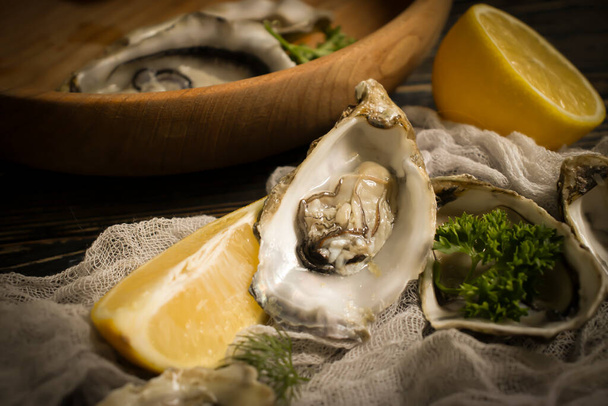 fresh oysters, lemon on wooden background - Photo, Image