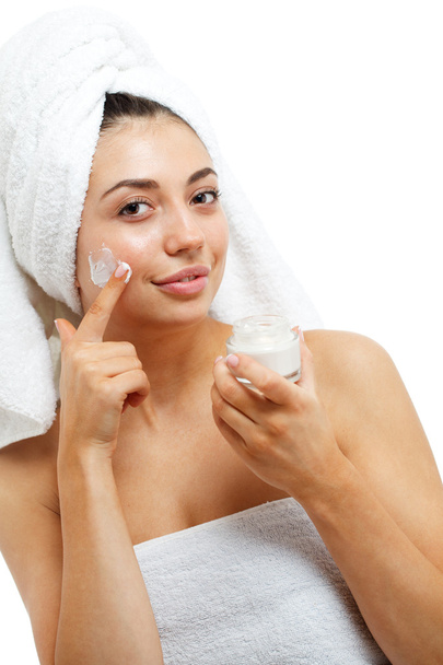Beautiful women applying moisturizer cosmetic cream on face. - Φωτογραφία, εικόνα