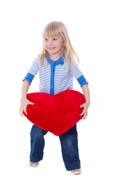 Cute child play with red heart - Foto, afbeelding