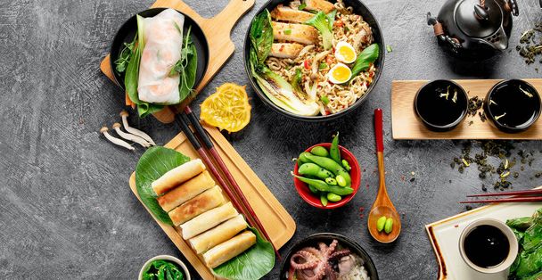 Asian food with various ingredients on dark background. Panorama. - Фото, изображение