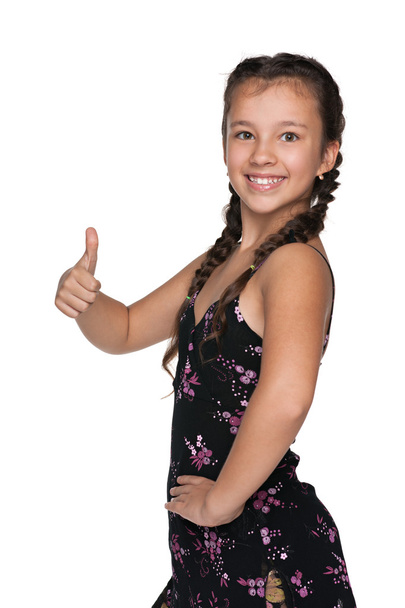 Happy young girl holds her thumb up - Photo, Image