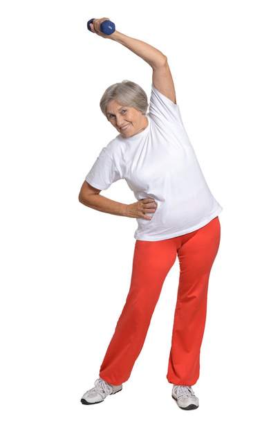 Senior woman exercising with dumbbell - Foto, afbeelding