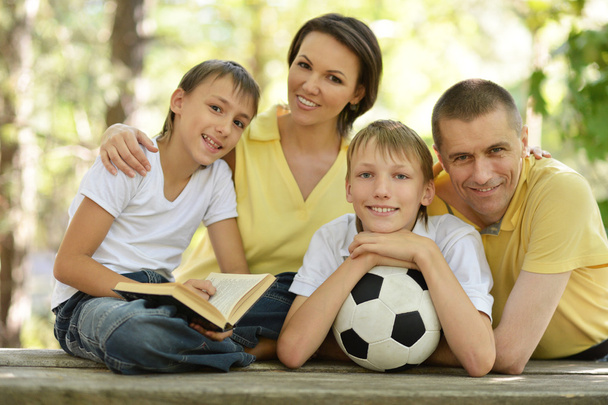 Happy family with ball and book - Φωτογραφία, εικόνα