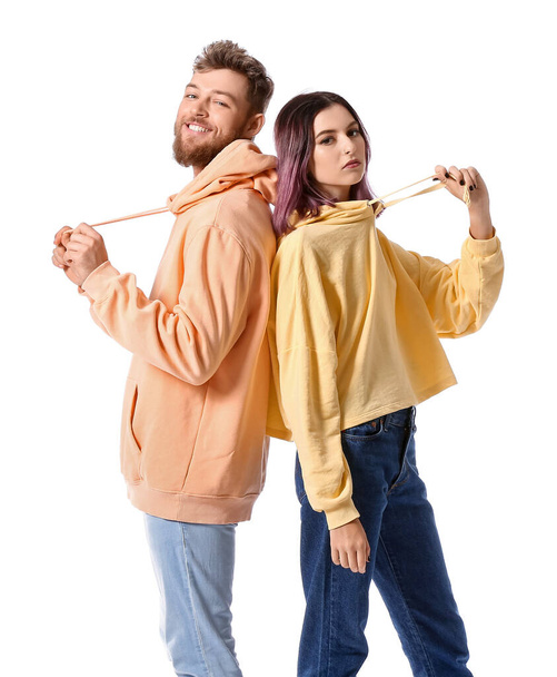 Cool young couple in hoodies on white background - Photo, image