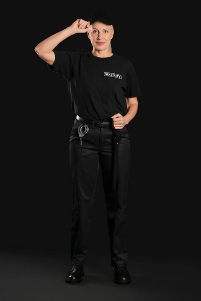 Female security guard on dark background - Zdjęcie, obraz