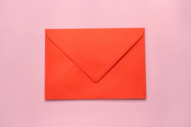 Red envelope on pink background, top view - Photo, Image