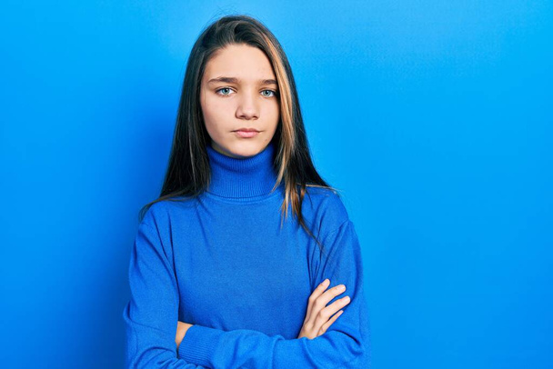Young brunette girl wearing turtleneck sweater skeptic and nervous, disapproving expression on face with crossed arms. negative person.  - Fotoğraf, Görsel