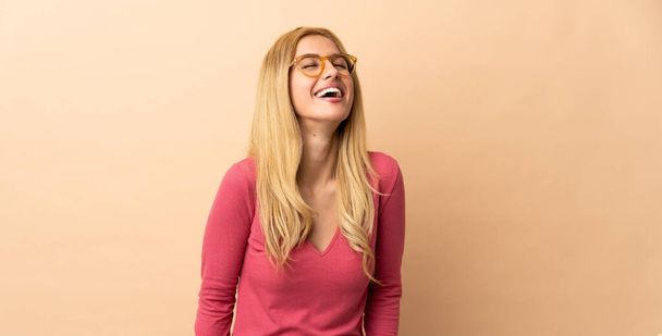 Young Uruguayan blonde woman over isolated background laughing - Photo, Image