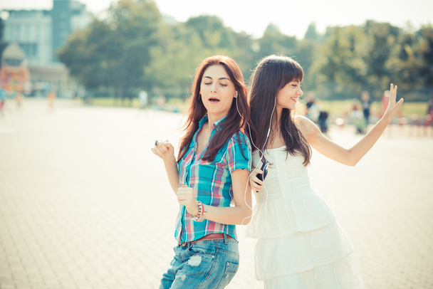 beautiful hipster young women sisters friends dancing - Photo, Image