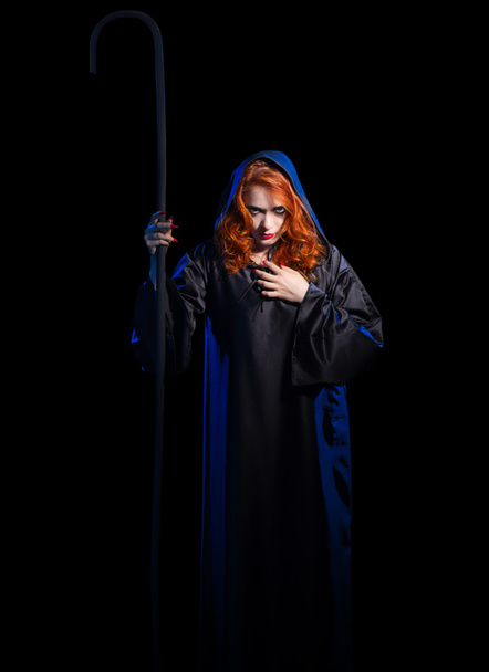 Young witch with staff - Foto, afbeelding