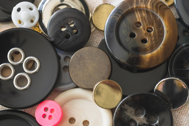 buttons with different sewing accessories on a wooden background - Φωτογραφία, εικόνα