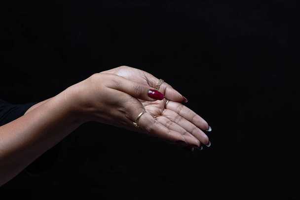 close up of a female hand  on a dark background - Photo, Image