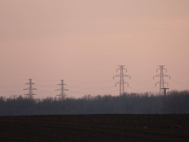 high voltage tower in the field - 写真・画像