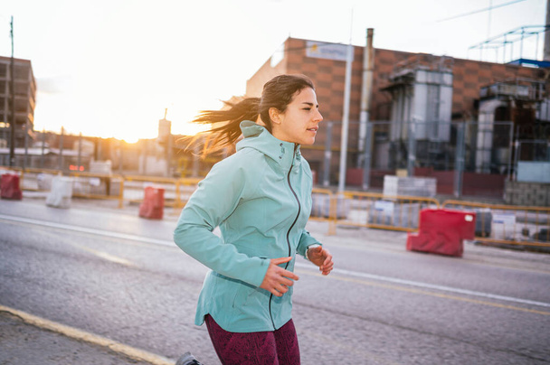 Sporty woman running in the city. - Valokuva, kuva