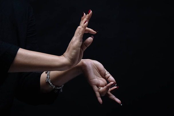woman hands on a dark background - Photo, image