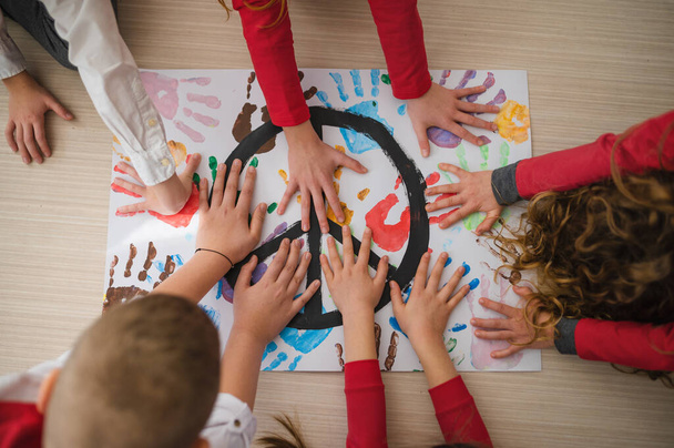 Top view of children making a poster of peace sign at school. - Fotoğraf, Görsel