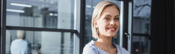 Positive businesswoman looking at camera in office, banner  - Photo, image