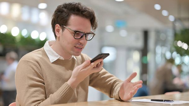 Angry Man Talking on Smartphone, in Office  - Photo, Image