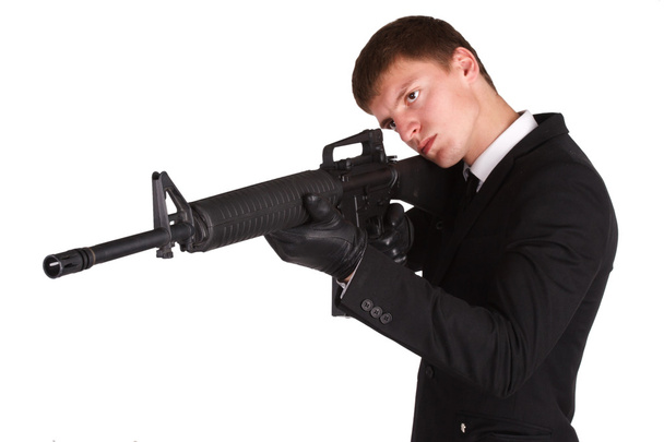 man in black costume and rifle - Foto, afbeelding