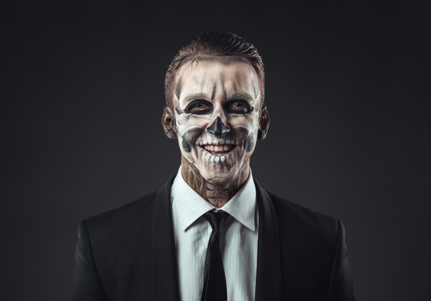 Portrait laughing businessman with makeup skeleton - Foto, Bild
