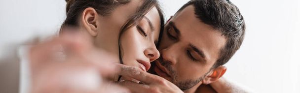 Young man touching face of brunette girlfriend at home, banner  - Foto, imagen