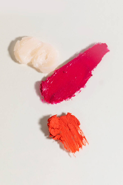 isolated smear beauty cosmetics texture of lip balm, lipstick, white background - Fotó, kép