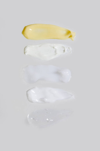 isolated smear beauty cosmetics texture of face cream, white background - Photo, image