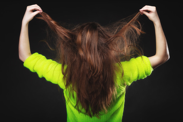 Woman pulling her long hair - Фото, изображение