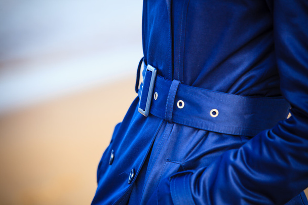 Girl in blue coat with belt - Foto, afbeelding