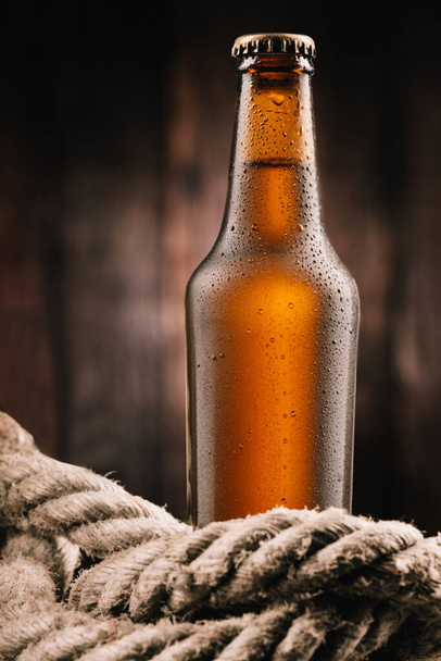 Bottle of beer a wooden background close u - Foto, Imagem