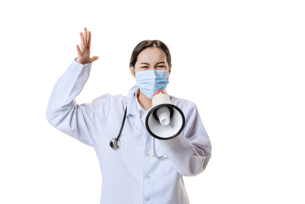 Portrait of young woman, doctor, therapeutic or medical advisor wearing face mask and white uniform isolated on white background. Health care concept - Photo, Image