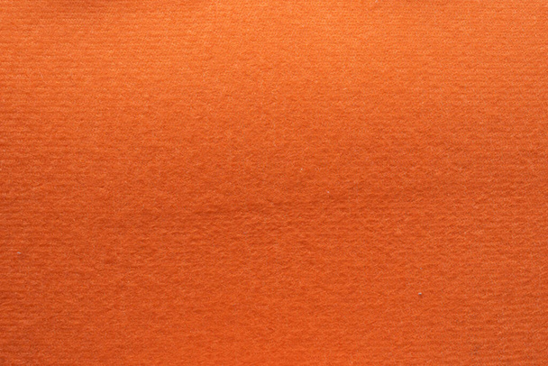 最上階の床に配置されたオレンジのフランネルは美しいフェルト生地の背景で、テキストやその他のデザインで使用するためのデザインに最適です。オレンジ色のフランネル背景画像の質感 - 写真・画像