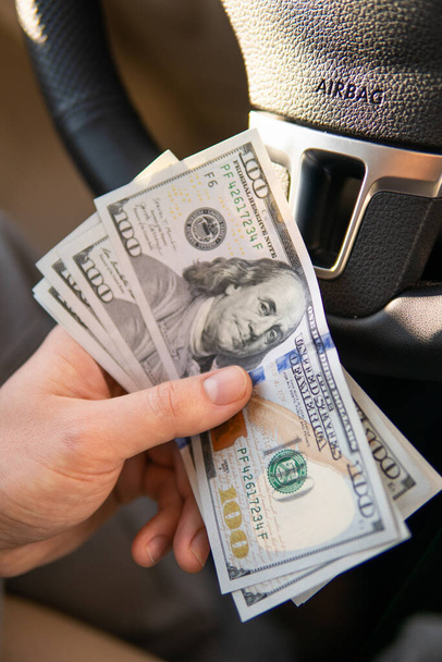 Closeup hand money in car and money for loan credit financial, lease and car rental concept - Photo, Image
