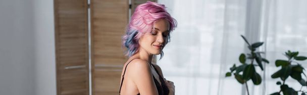 young woman with pink hair in dark lace bra near blurred folding screen, banner - Foto, Imagem