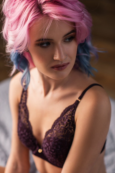 portrait of young woman in dark bra looking away - Fotó, kép