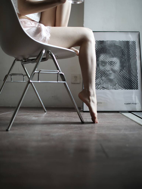 beautiful sexy woman in black lingerie sitting on chair in studio - Fotografie, Obrázek