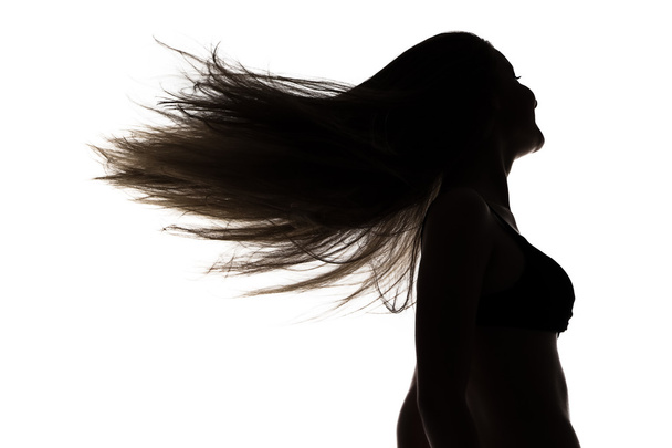 Silhouette of girl with waving hair in profil - Foto, afbeelding