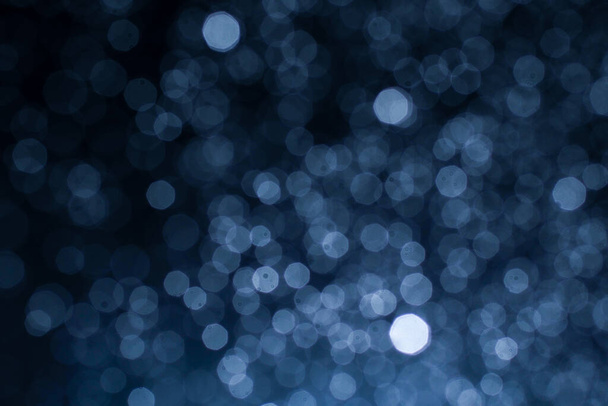 Dark blue abstract background with bokeh. Colorful twinkling lights bokeh light background. - 写真・画像