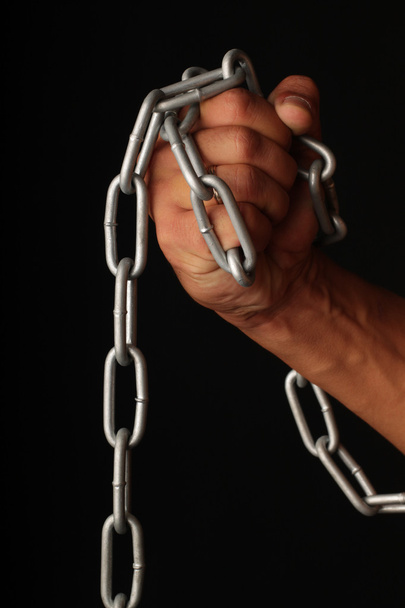 Hand and a chain. - Фото, изображение